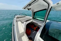 2020 Axopar 37 Cross Cabin with open storage, ocean view, and clear sky.