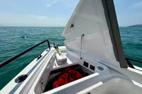 Axopar 37 Cross Cabin 2020 with open storage compartment, ocean view in background.