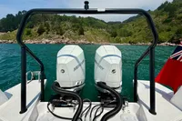 Axopar 37 Cross Cabin with dual Mercury engines on a scenic waterway.
