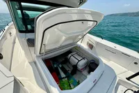 2020 Axopar 37 Cross Cabin boat with open multi-storage compartment, ocean view.