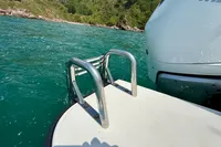 Boat ladder on Axopar 37 Cross Cabin, 2020, near scenic shoreline.