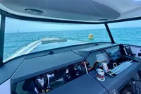 2020 Axopar 37 Cross Cabin interior with ocean view, featuring modern dashboard and controls.