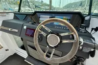 2020 Axopar 37 Cross Cabin helm with joystick control and navigation display.