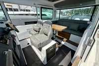 2020 Axopar 37 Cross Cabin interior with seating, table, and joystick controls.