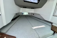 Interior cabin of 2020 Axopar 37 Cross Cabin with gray cushions and overhead window.