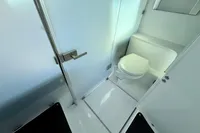 Modern bathroom in 2020 Axopar 37 Cross Cabin boat, featuring sleek design and compact toilet.