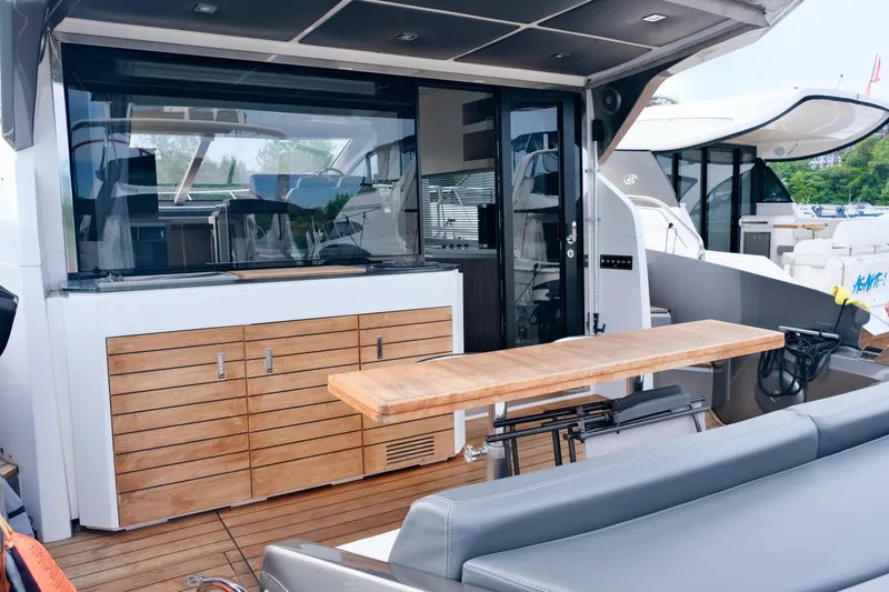  Yacht Photos Pics 2022 Sessa Marine Coupe 47 yacht with sleek outdoor seating and wooden cabinetry.