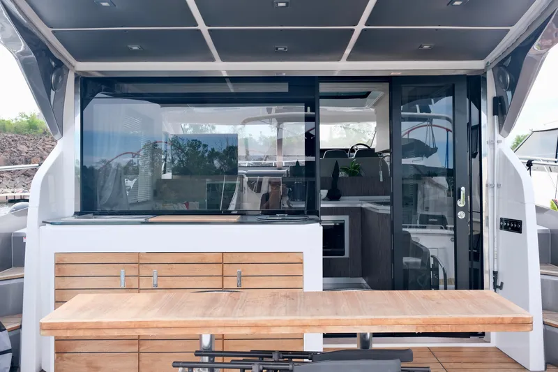  Yacht Photos Pics 2022 Sessa Marine Coupe 47 yacht interior with sleek design and wooden accents.