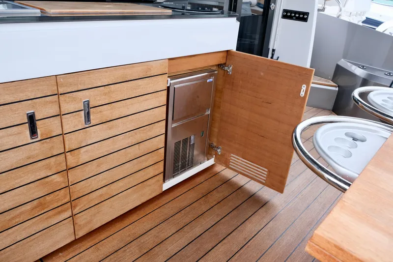  Yacht Photos Pics Luxury yacht Sessa Marine Coupe 47, 2022 model, featuring sleek wooden cabinetry and modern design.