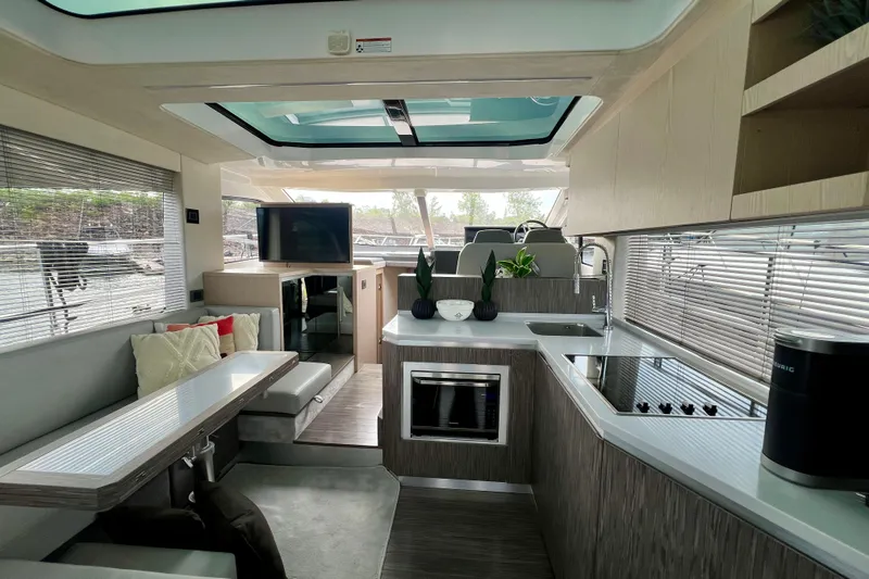 Yacht Photos Pics Luxurious interior of 2022 Sessa Marine Coupe 47 yacht with modern kitchen and seating area.