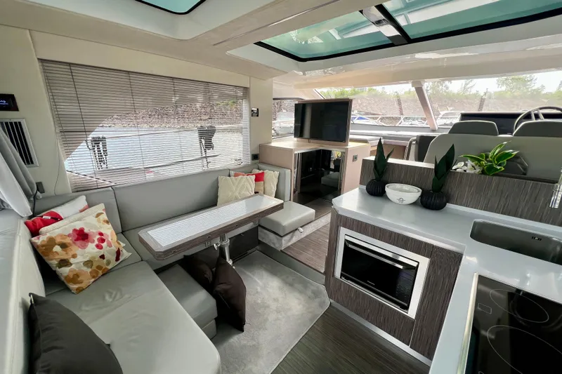  Yacht Photos Pics Luxurious interior of 2022 Sessa Marine Coupe 47 yacht with modern kitchen and seating area.