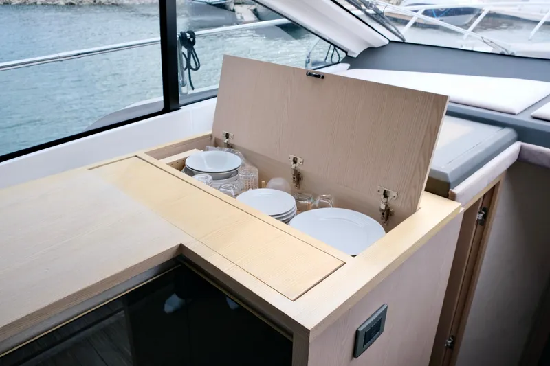  Yacht Photos Pics Interior of 2022 Sessa Marine Coupe 47 yacht with open storage compartment.