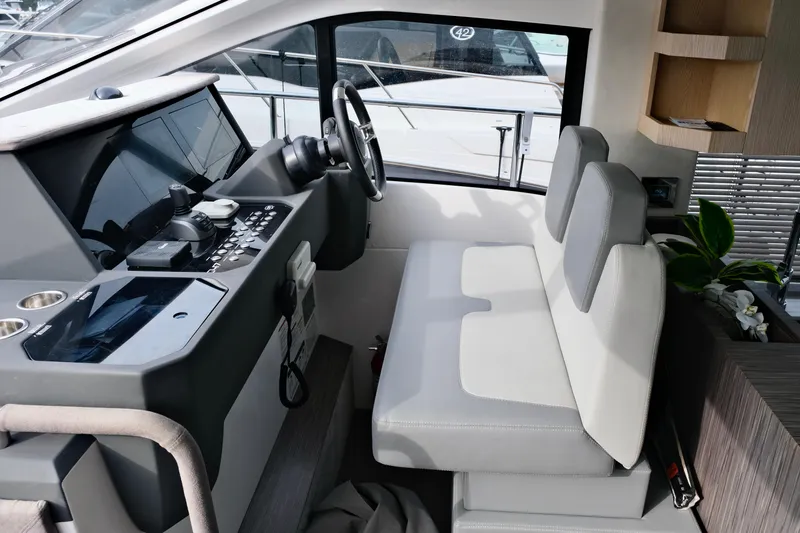  Yacht Photos Pics Interior of 2022 Sessa Marine Coupe 47 yacht, featuring modern helm and seating area.