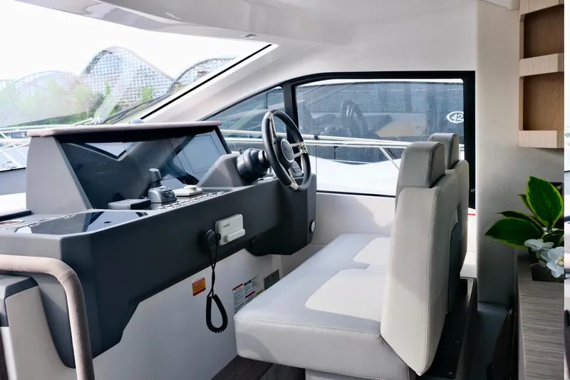  Yacht Photos Pics Interior of 2022 Sessa Marine Coupe 47 yacht, featuring modern helm and seating.