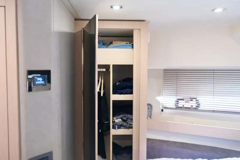  Yacht Photos Pics Interior of 2022 Sessa Marine Coupe 47, featuring a sleek wardrobe and modern lighting.