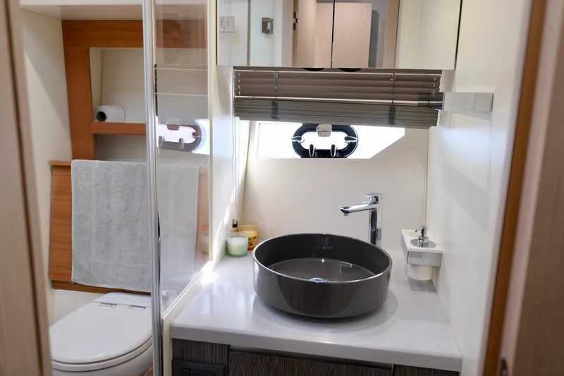  Yacht Photos Pics Modern bathroom interior of 2022 Sessa Marine Coupe 47 yacht.