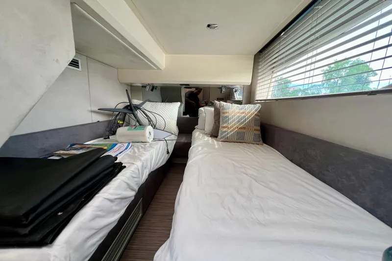  Yacht Photos Pics Interior cabin of 2022 Sessa Marine Coupe 47 with twin beds and window blinds.