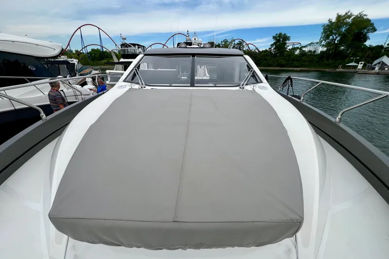  Yacht Photos Pics 2022 Sessa Marine Coupe 47 yacht docked, showcasing sleek design and spacious deck.