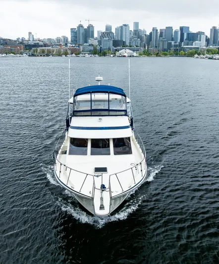 Bleu Fish Yacht Photos Pics 1988 Tollycraft 44 CPMY yacht cruising in urban waterfront setting.