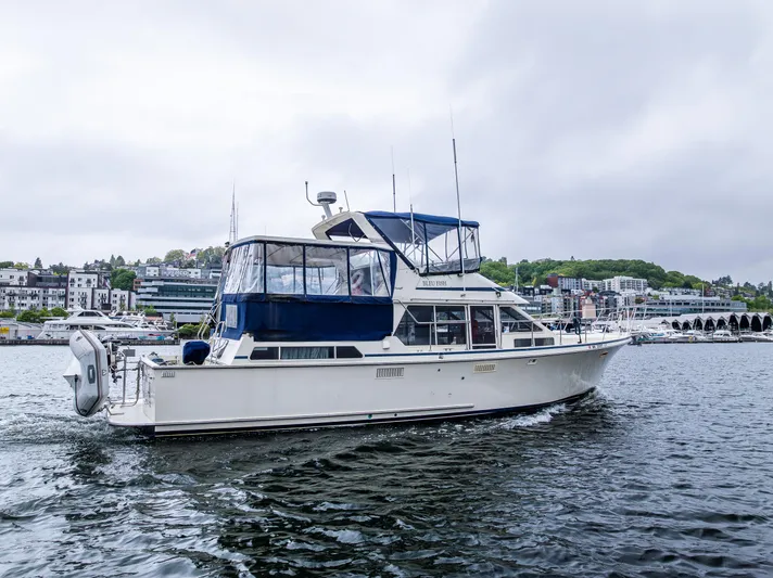 Bleu Fish Yacht Photos Pics 1988 Tollycraft 44 CPMY yacht cruising on a calm waterway.