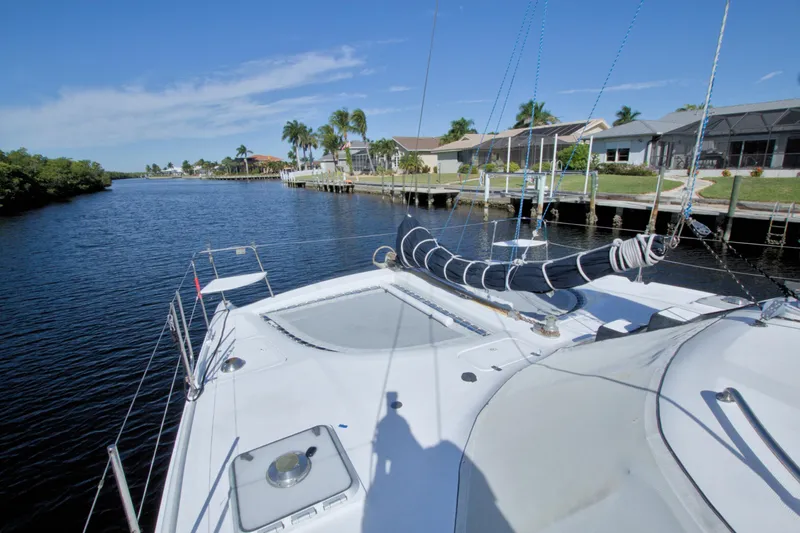 Scout Yacht Photos Pics Sailing on a 1996 Manta 40 catamaran in a scenic canal with waterfront homes.