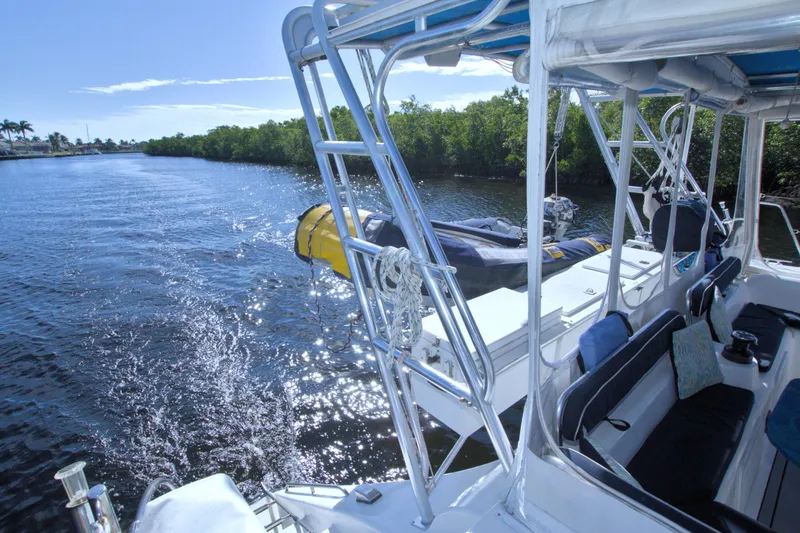 Scout Yacht Photos Pics 1996 Manta 40 catamaran on a sunny river, featuring sleek design and comfortable seating.