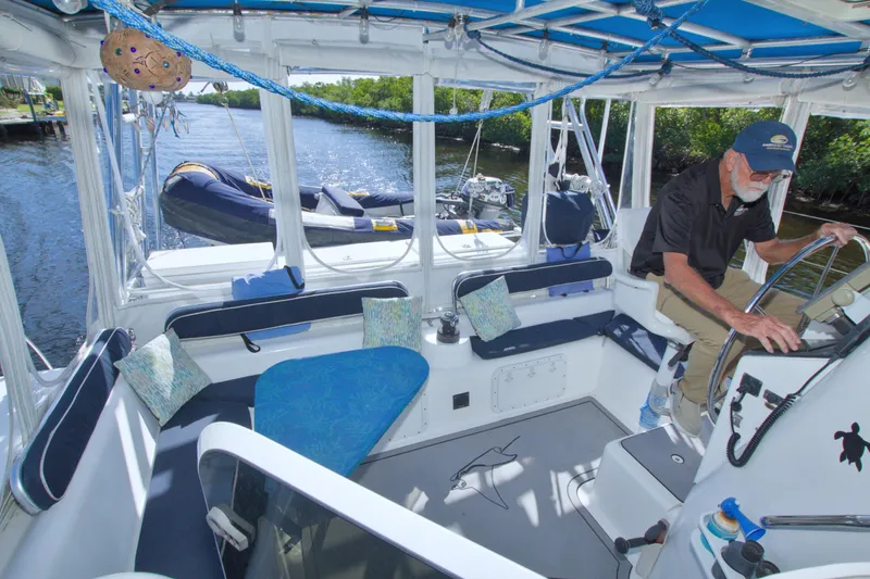 Scout Yacht Photos Pics Man operating a 1996 Manta 40 sailboat, featuring a spacious cockpit and comfortable seating.