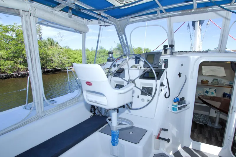 Scout Yacht Photos Pics 1996 Manta 40 sailboat cockpit with steering wheel, navigation equipment, and cabin entrance.
