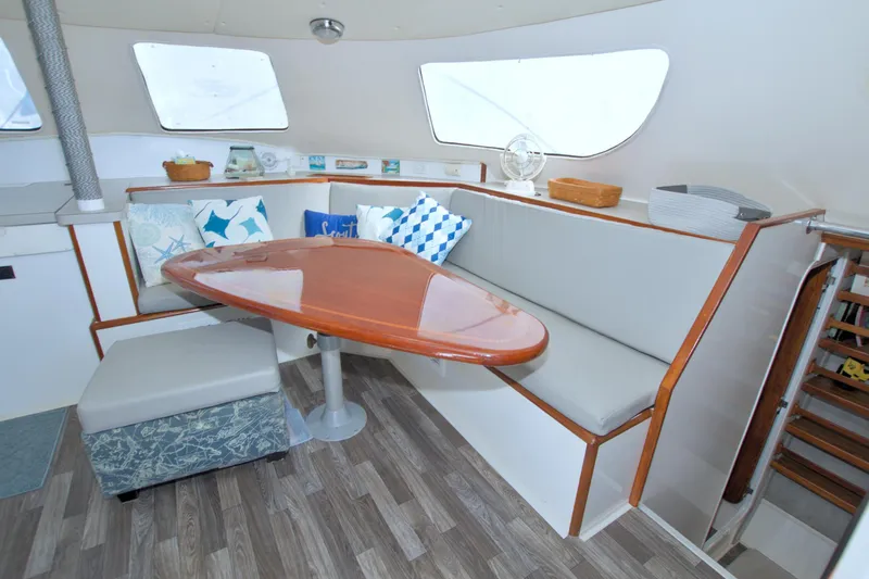 Scout Yacht Photos Pics Interior of 1996 Manta 40 yacht with cozy seating and wooden table.