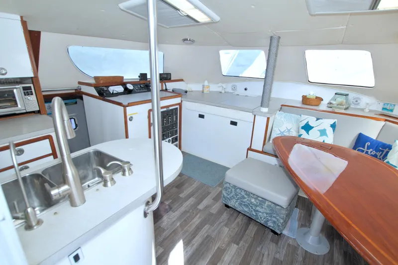 Scout Yacht Photos Pics Interior of 1996 Manta 40 yacht with modern kitchen and cozy seating area.