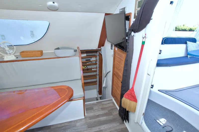 Scout Yacht Photos Pics Interior of 1996 Manta 40 yacht with seating, table, and stairs.