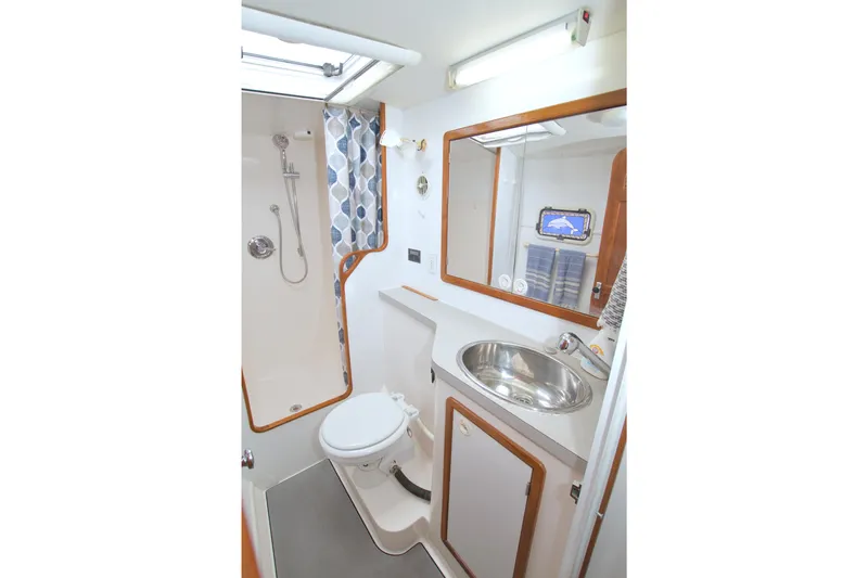 Scout Yacht Photos Pics Bathroom interior of 1996 Manta 40 yacht with shower, sink, and toilet.