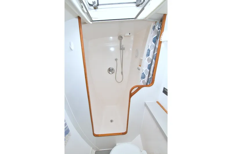Scout Yacht Photos Pics 1996 Manta 40 yacht bathroom with shower, white interior, and wooden trim.