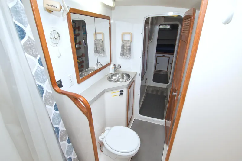 Scout Yacht Photos Pics 1996 Manta 40 yacht bathroom with sink, mirror, and toilet.