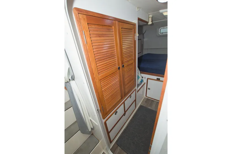 Scout Yacht Photos Pics Interior of 1996 Manta 40 sailboat with wooden closet and cozy cabin space.