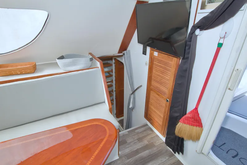 Scout Yacht Photos Pics Interior of a 1996 Manta 40 boat with TV, seating, and wooden accents.