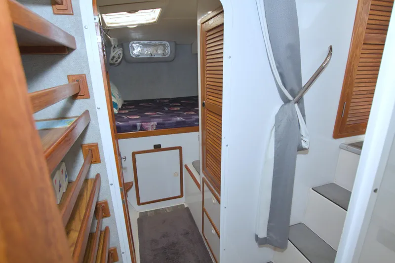 Scout Yacht Photos Pics Interior of 1996 Manta 40 sailboat with wooden accents and cozy sleeping area.