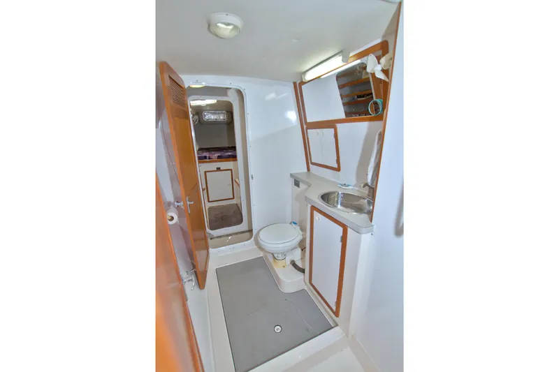 Scout Yacht Photos Pics Bathroom interior of 1996 Manta 40 yacht with sink, toilet, and storage cabinets.