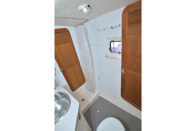 Scout Yacht Photos Pics 1996 Manta 40 yacht bathroom with wooden cabinets and stainless steel sink.