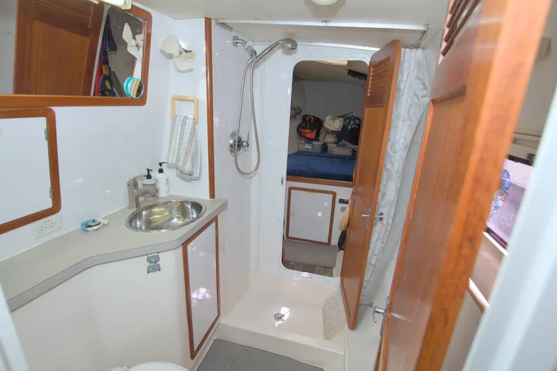 Scout Yacht Photos Pics Bathroom interior of 1996 Manta 40 yacht with sink, shower, and wooden accents.