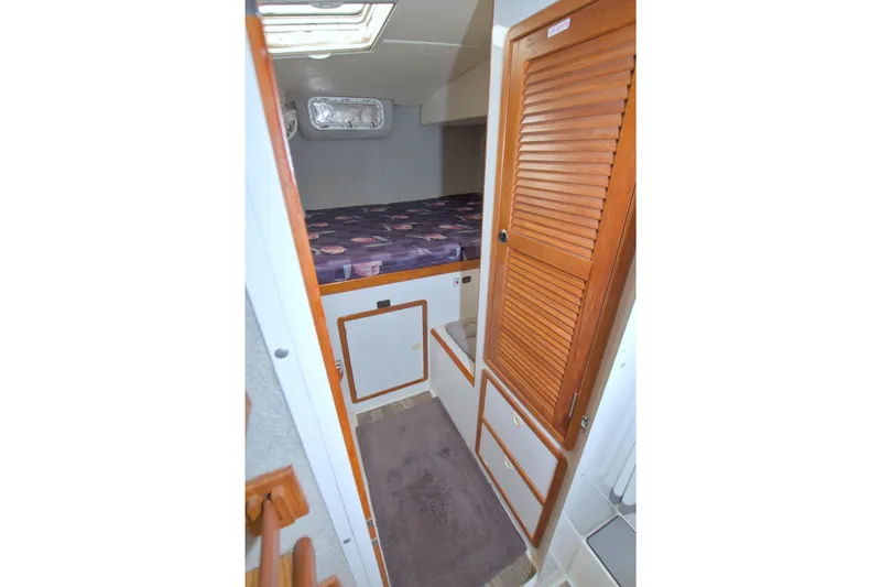 Scout Yacht Photos Pics 1996 Manta 40 interior cabin with bed, wooden closet, and storage.