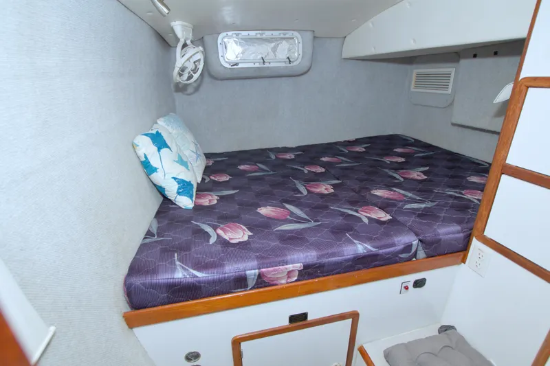 Scout Yacht Photos Pics Cozy cabin interior of 1996 Manta 40 yacht with floral bedding and pillow.