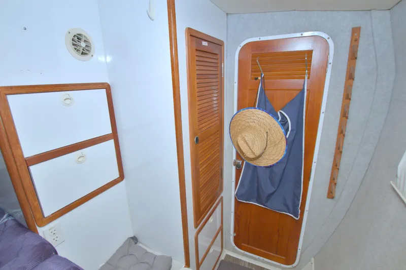 Scout Yacht Photos Pics Interior of 1996 Manta 40 boat with wooden cabinets and door, hat hanging.