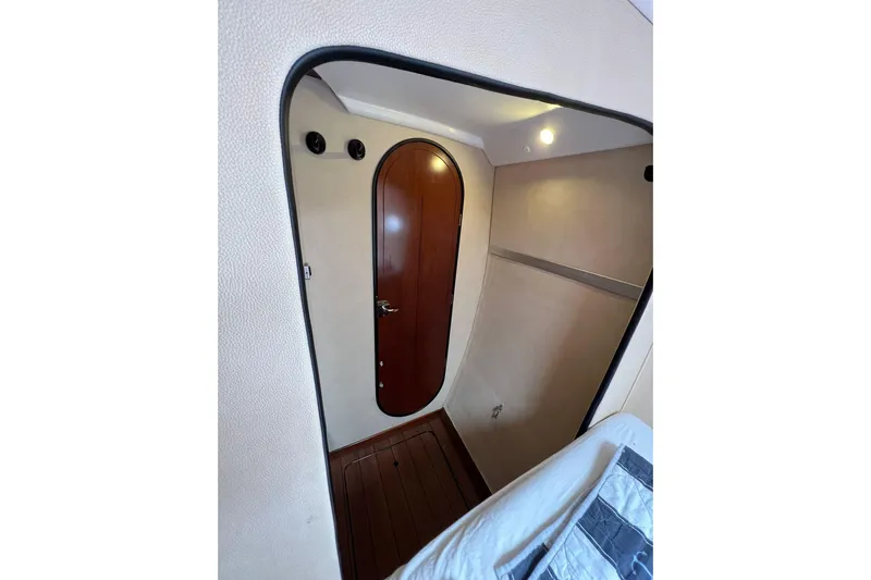 Searenity Yacht Photos Pics Interior of 2005 Fountaine Pajot LAVEZZI 40 yacht, featuring a wooden door and cozy cabin space.