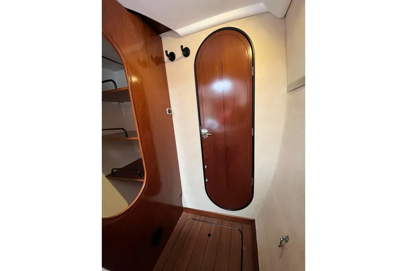 Searenity Yacht Photos Pics Interior of 2005 Fountaine Pajot LAVEZZI 40, featuring wooden door and shelving.