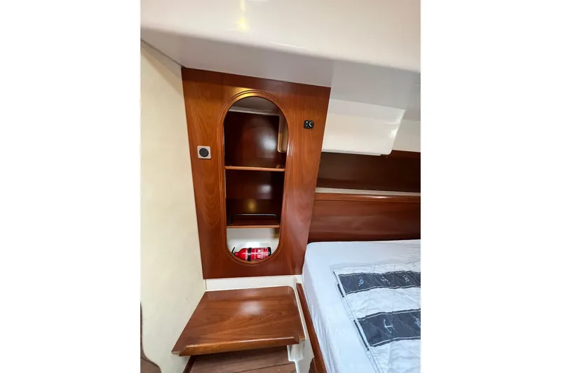 Searenity Yacht Photos Pics Interior of 2005 Fountaine Pajot LAVEZZI 40 yacht with wooden cabinetry and bed.