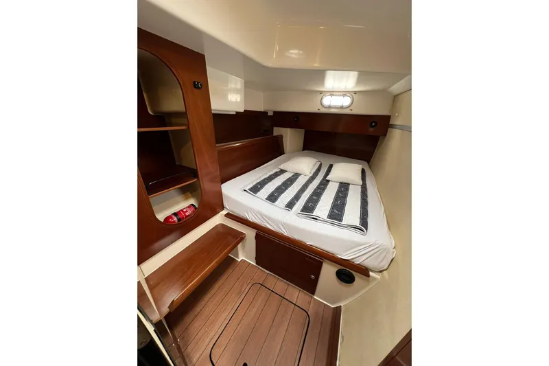 Searenity Yacht Photos Pics Cabin interior of 2005 Fountaine Pajot LAVEZZI 40 catamaran with cozy bed and wooden accents.