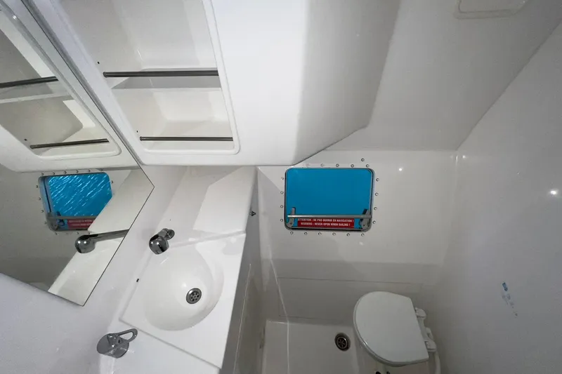 Searenity Yacht Photos Pics Bathroom interior of 2005 Fountaine Pajot LAVEZZI 40 catamaran with sink, toilet, and window.