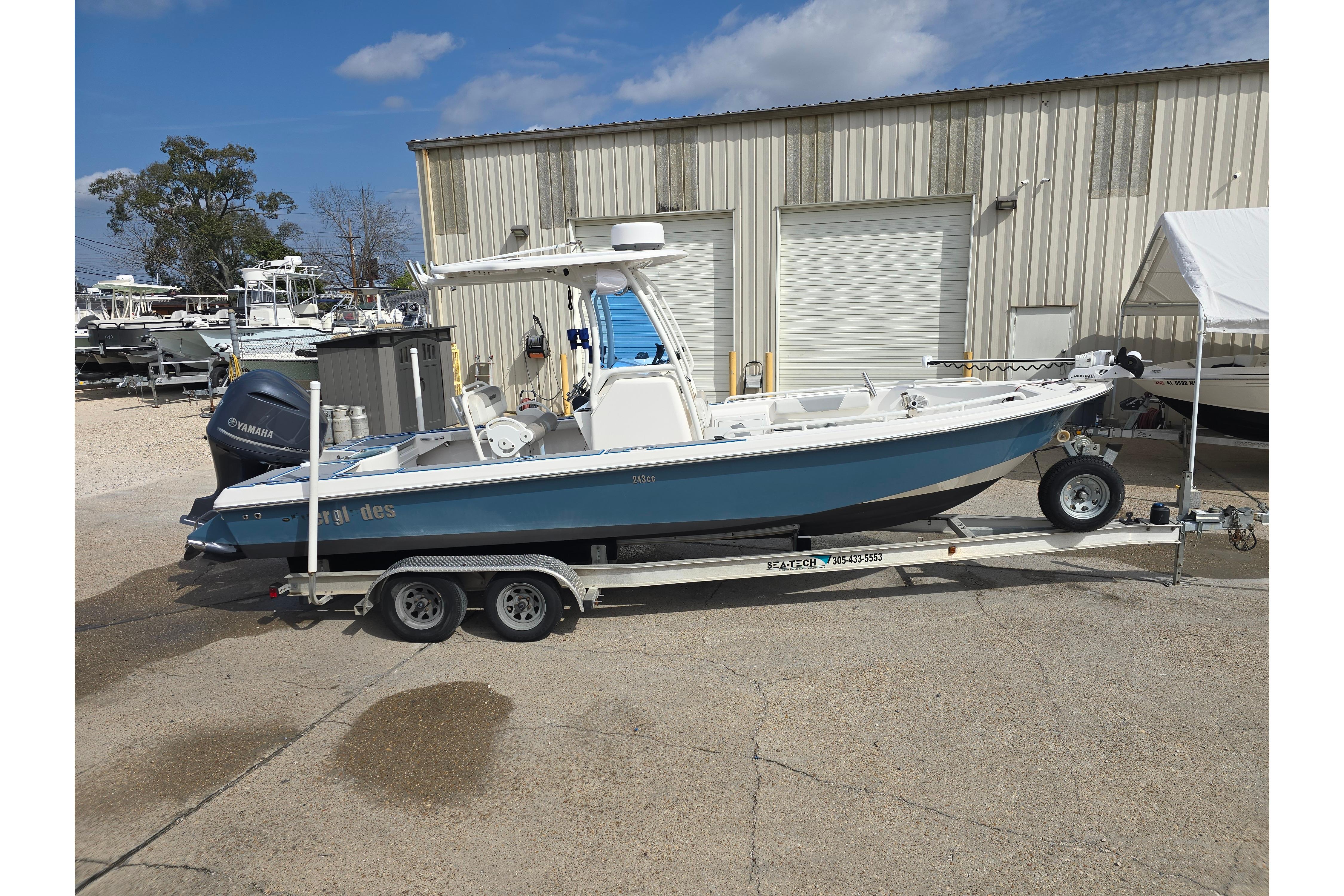 2012 Everglades 243 Center Console boat on trailer, parked outdoors.