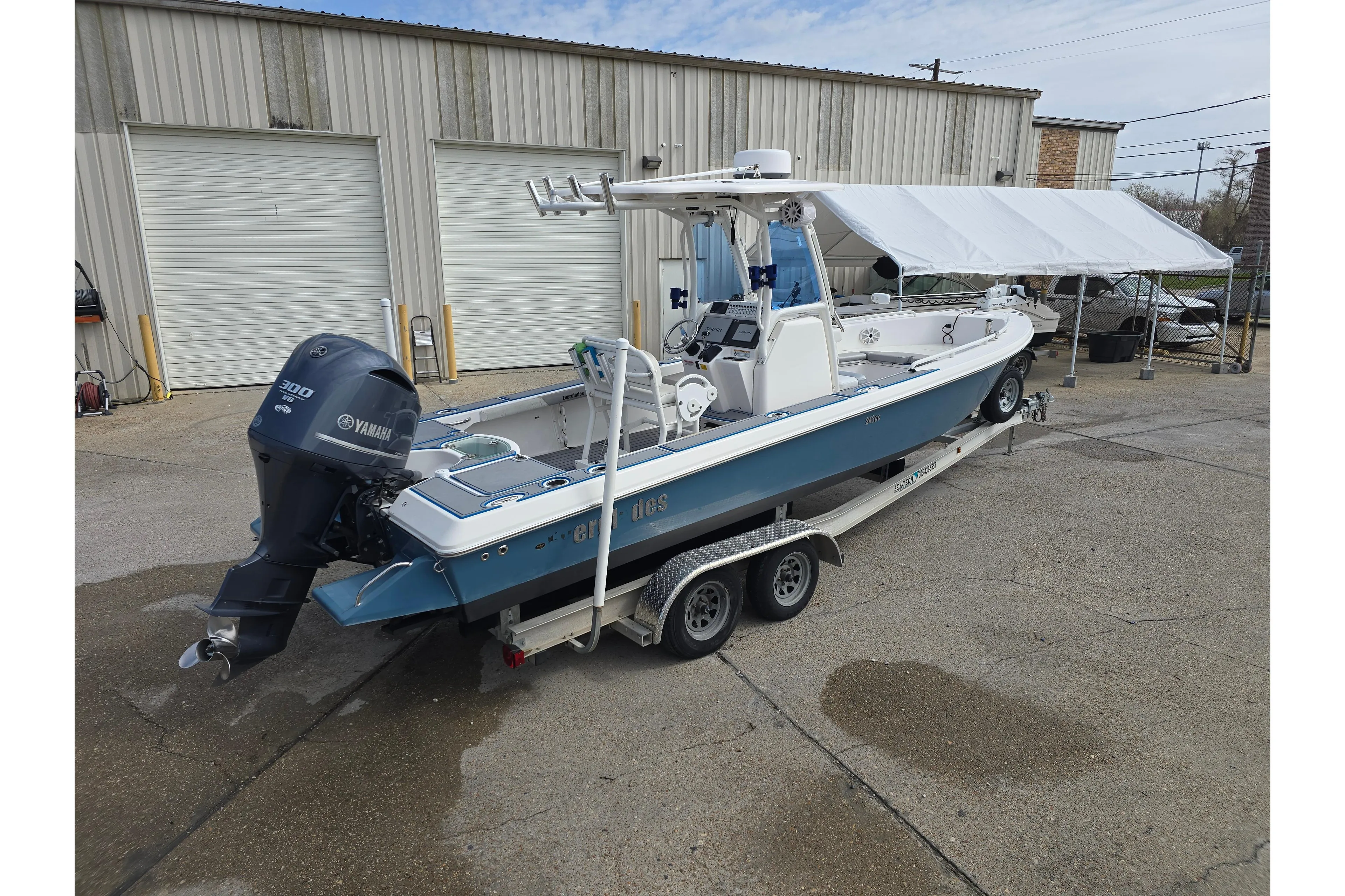 2012 Everglades 243 Center Console boat on trailer, featuring Yamaha 300 engine.